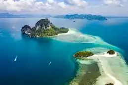an aerial view of islands in a tropical sea connected by white sand bars